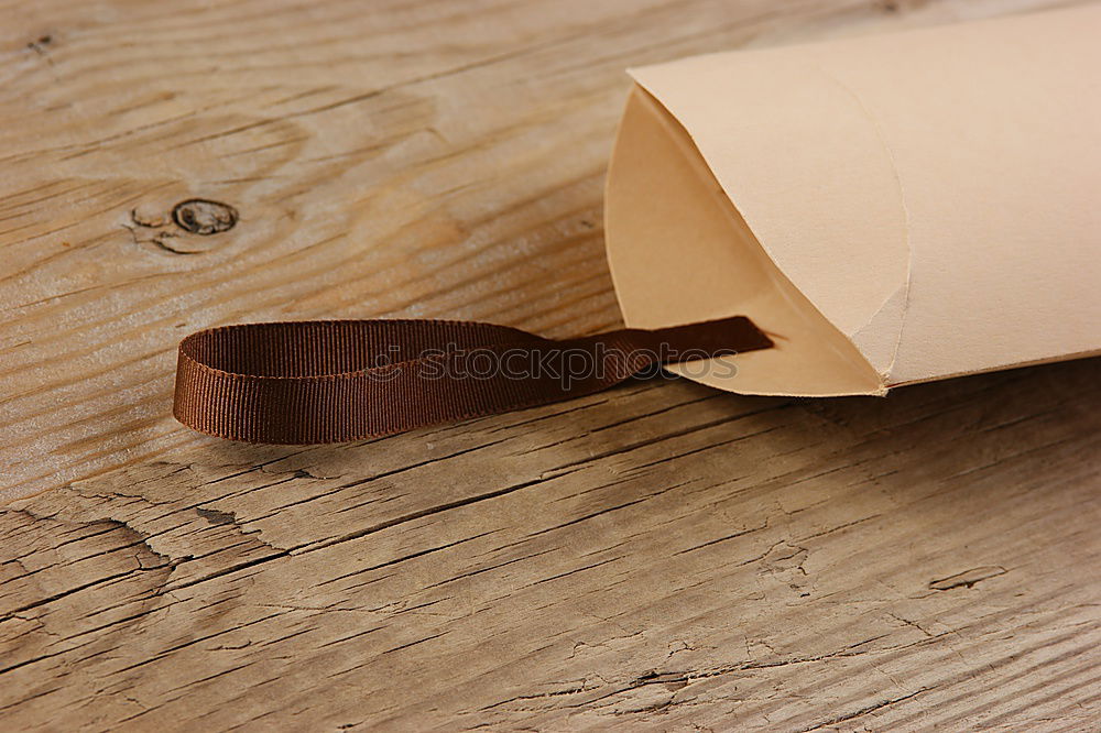 Handmade paper diary in brown leather cover over vintage wood