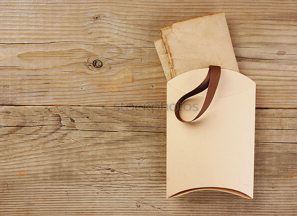 wooden desktop with books, watch and copy space for text