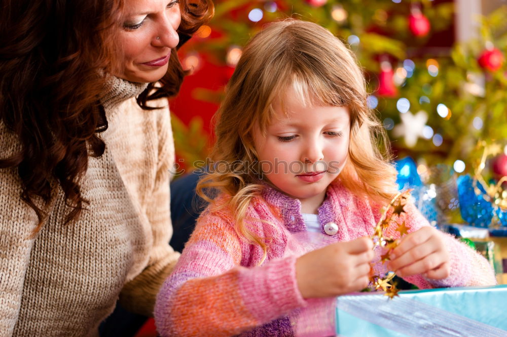 Similar – Girls tying baked Christmas gingerbread cookies with ribbon