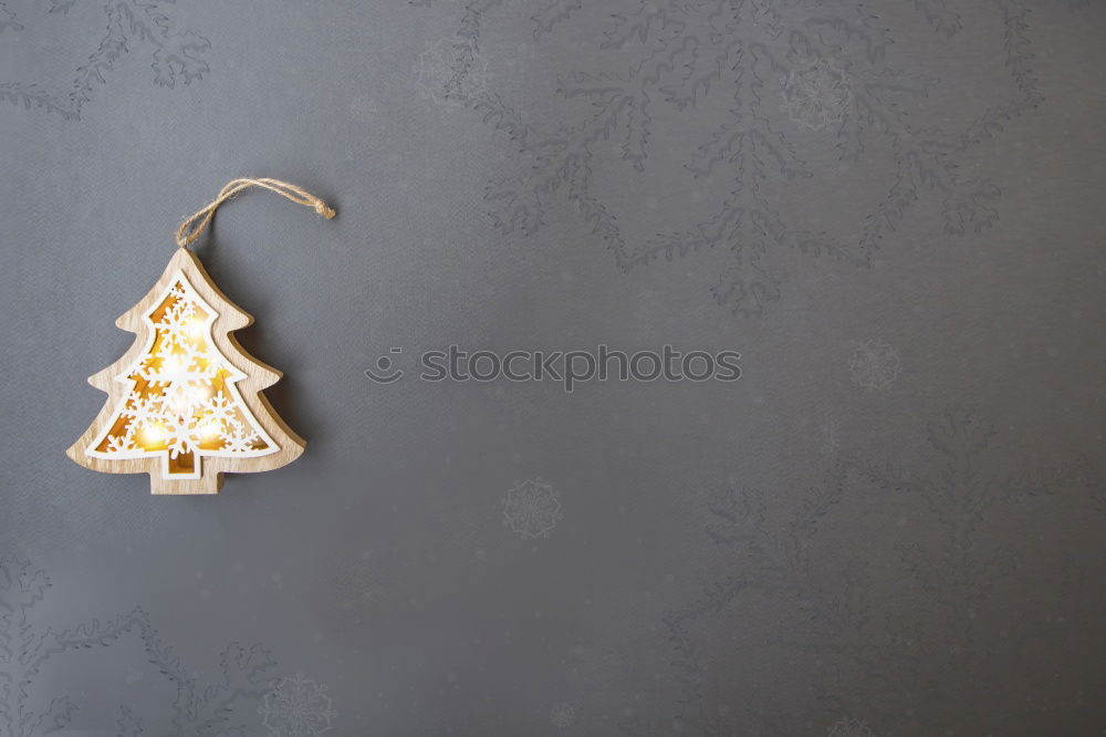 Similar – Image, Stock Photo Paper bag with wooden fir tree as decoration and burning candle standing on a table in front of a dark blue background