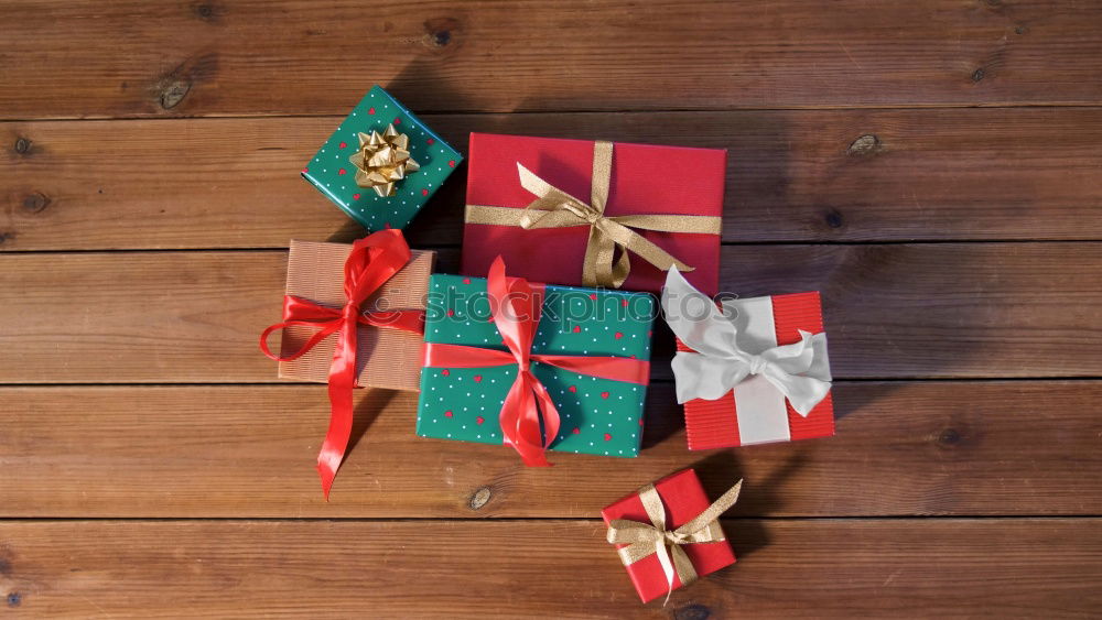 Similar – Image, Stock Photo colourful christmas parcels packed with christmas paper with red bow, on rustic wood. Christmas presents, lie nicely decorated with ribbon on wooden table. Many Christmas parcels wrapped with wrapping paper with Christmas motif. Concept gifts Advent.