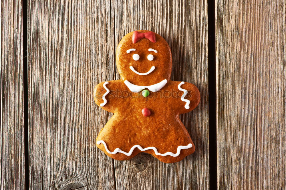 Similar – Image, Stock Photo Female hands tying baked Christmas gingerbread with ribbon