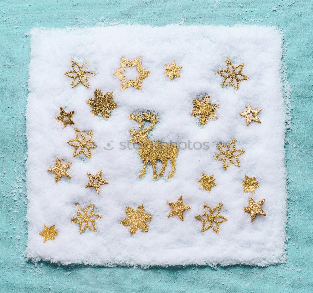 Christmas stag in the snow with golden snowflakes