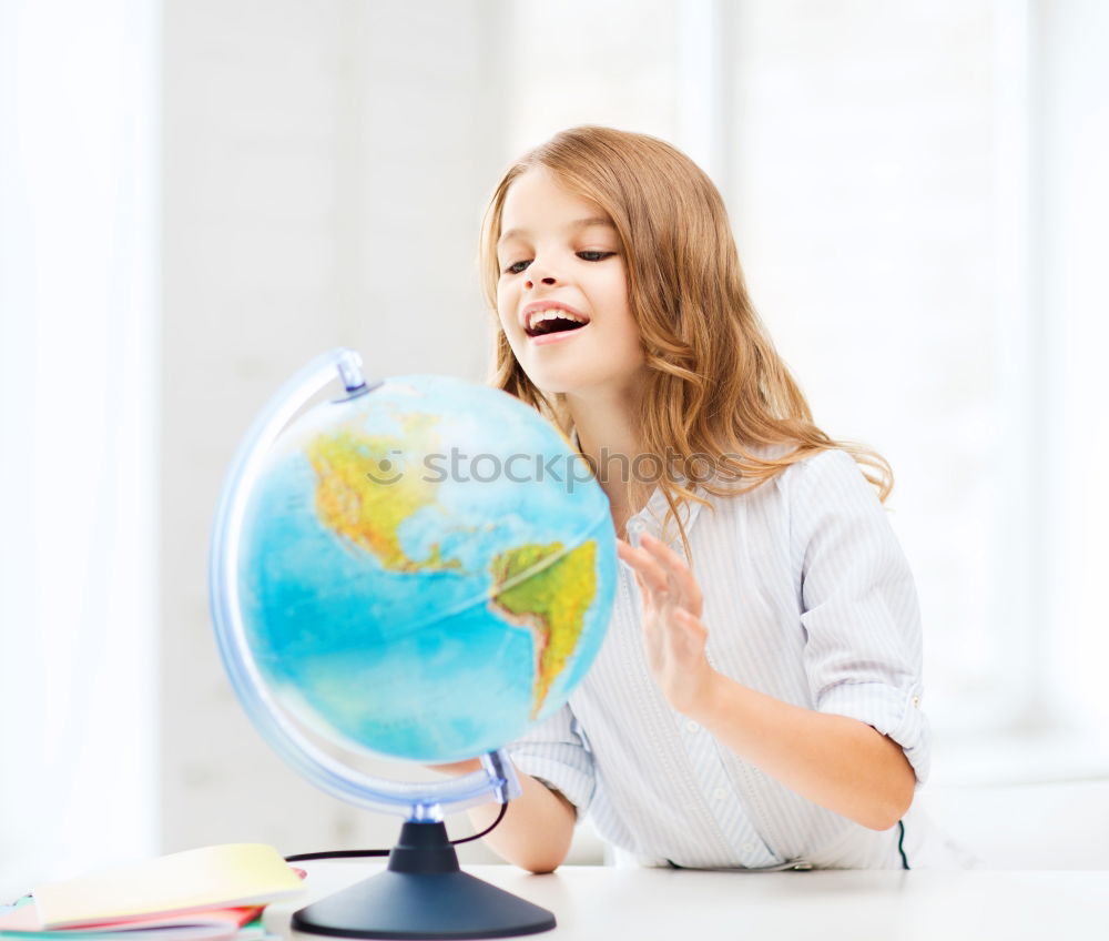 Similar – Image, Stock Photo Pupil girl pointing at globe