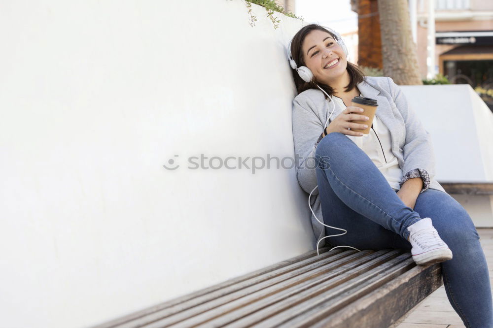 Similar – Happy woman with hat in city street, while using technology