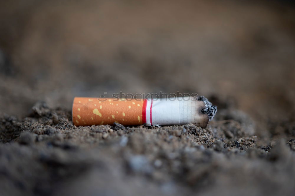 Similar – Image, Stock Photo A hand of a smoker with a burning cigarette and smoke, sprinkled with white paint