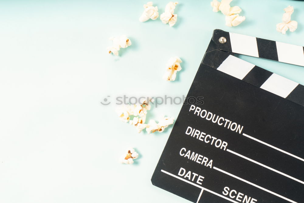 Similar – popcorn and clapboard on yellow background. Cinema concept