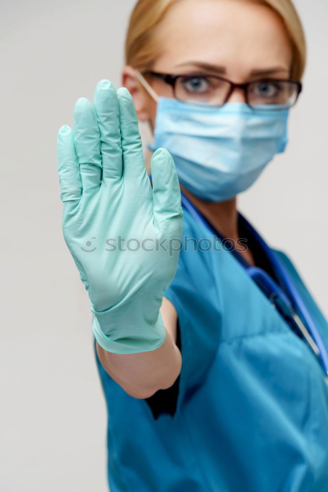 Similar – Image, Stock Photo Female doctor putting on her protective gloves