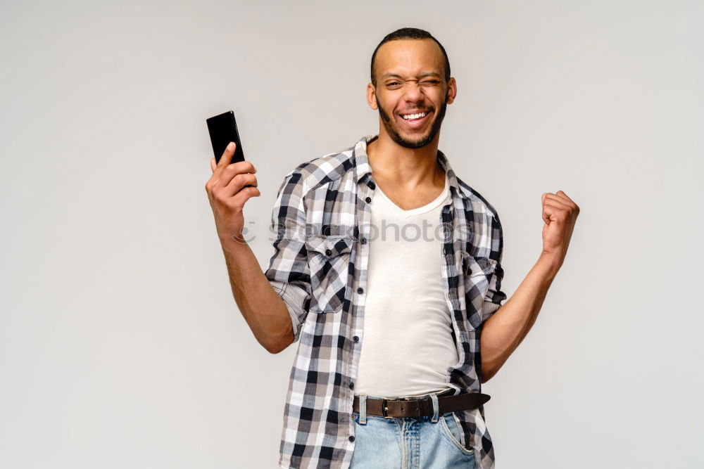 Similar – Image, Stock Photo Black young man with a smartphone in his hand