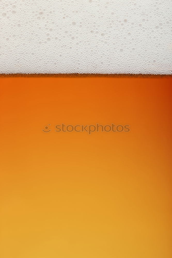 Extreme close up of beer in glass, side view