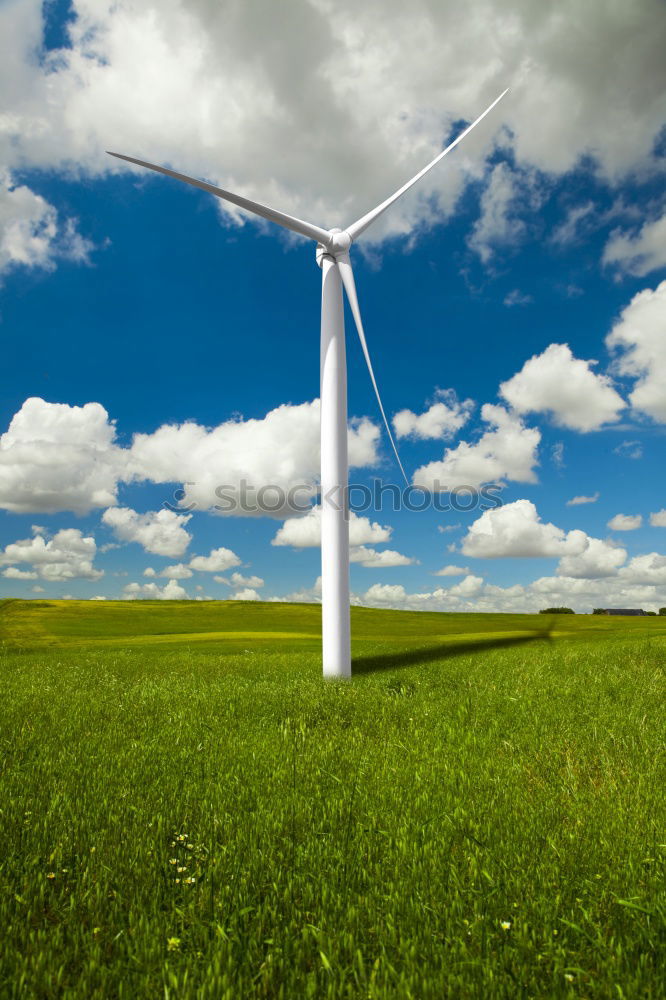 Similar – Image, Stock Photo Wind turbine for renewable power generation in front of a dike on the North Sea coast, long straight road. Wind turbine