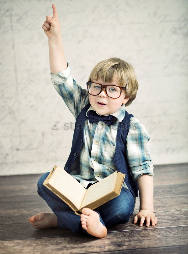 Similar – Image, Stock Photo One little boy reading to robot from cardboard boxes outdoors. Concept of science and education.