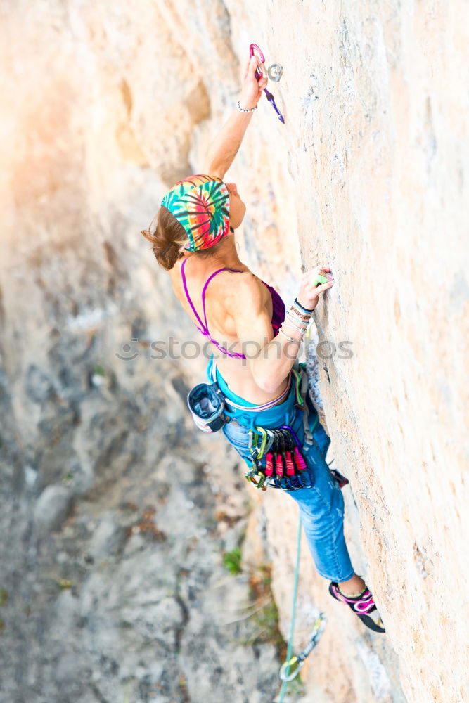 Similar – Young rock climber woman climbing the rock wall