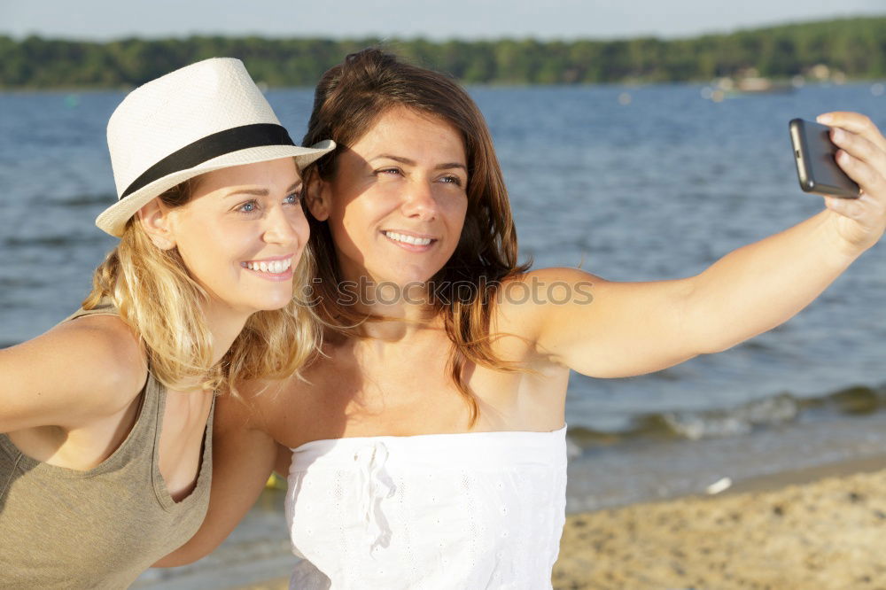 Similar – Image, Stock Photo Two girls taking selfie photograph with smart phone