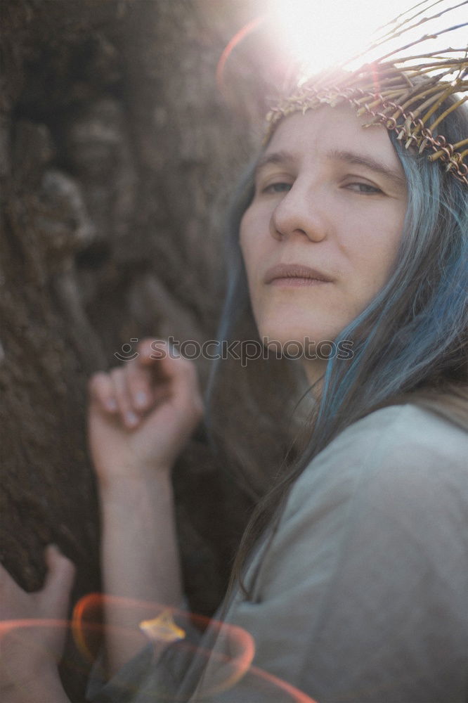 Similar – Image, Stock Photo Blonde woman and bearded man posing with plant branches in the hand at sunset, and blue sky in the background.