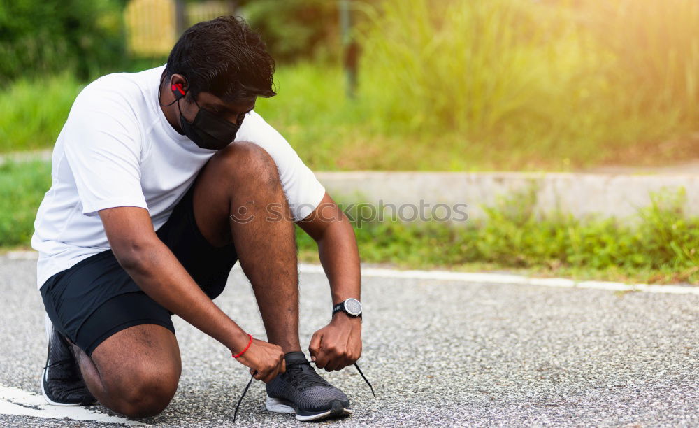 Similar – Sporty man sitting with towel and water bottle in gym floor