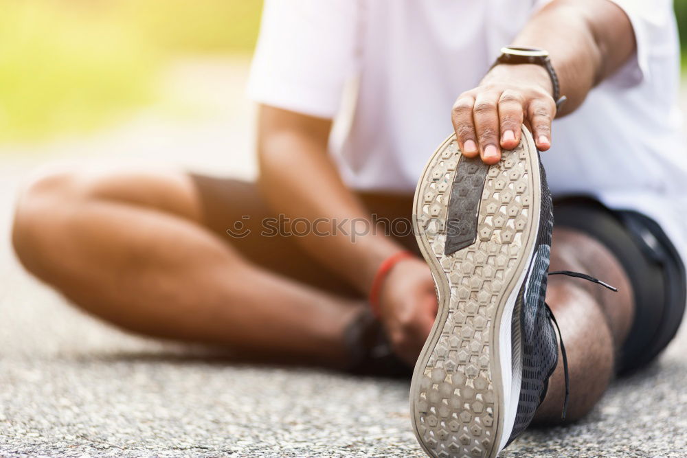 Similar – Runner get ready for run, tying sneakers shoelaces