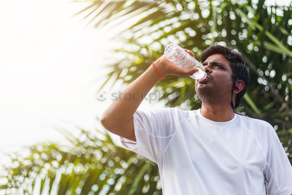 Similar – Image, Stock Photo Young black man drinking water before running outdoors