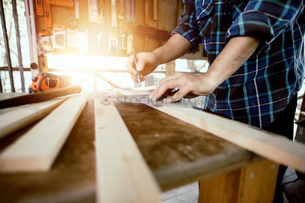 Similar – Carpenter with circular saw cutting a wooden.