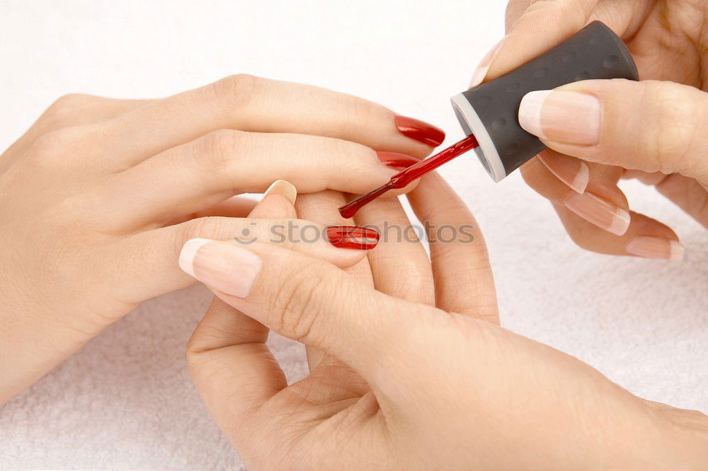 Similar – Female hand with red painted fingernails holding a bottle of red nail polish