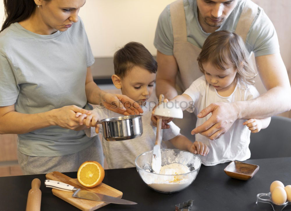 Similar – Image, Stock Photo Little sisters cooking with her mother in the kitchen.