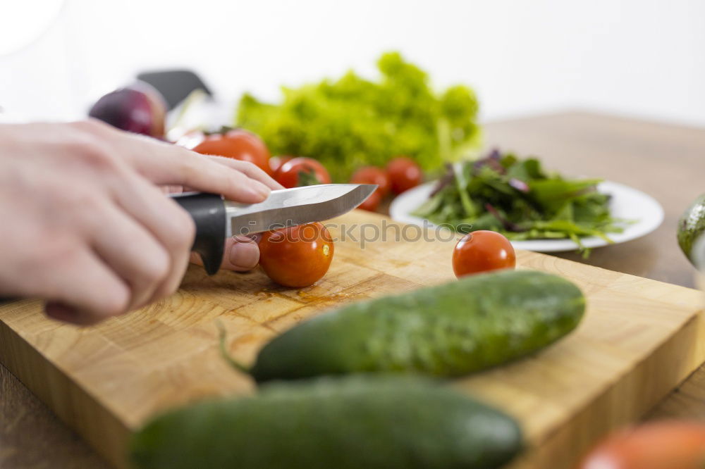 Similar – process of slicing carrots on slices on a kitchen board