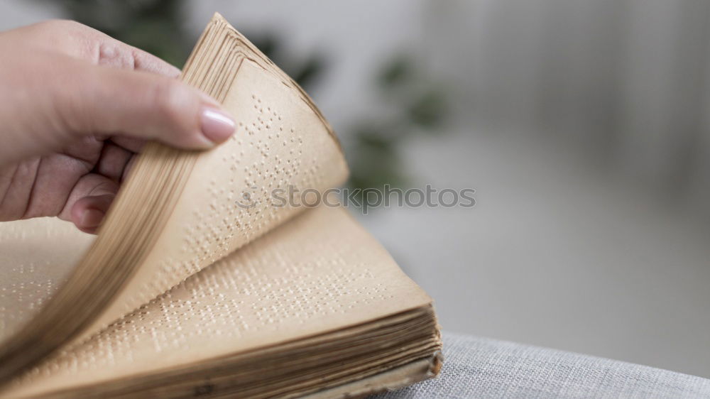 Similar – Young woman putting old books to paper bag in antique bookstore