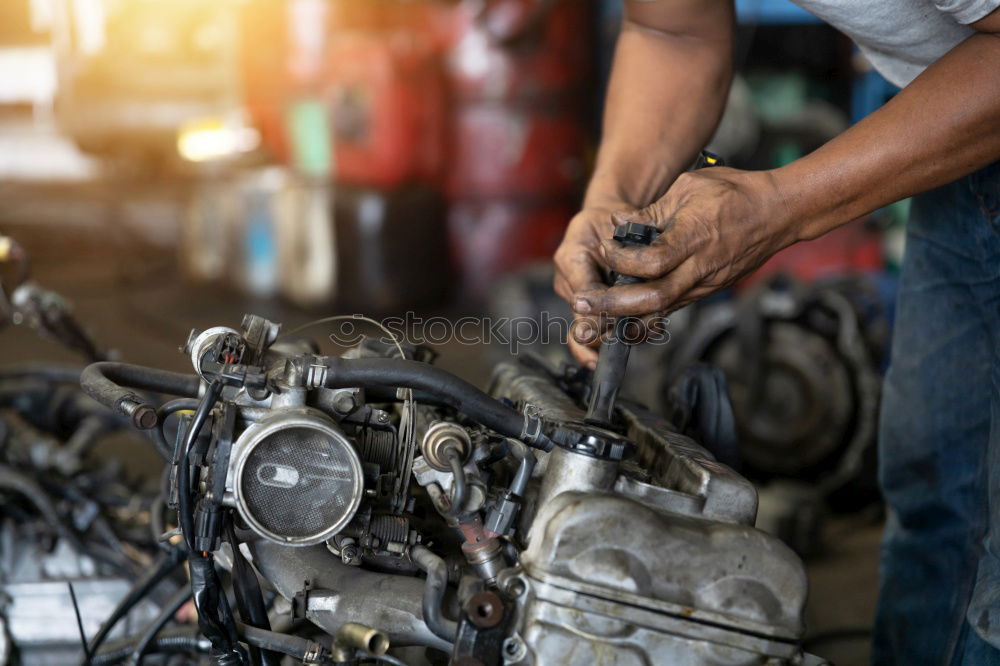 Similar – Professional Mechanic Repairing Car.