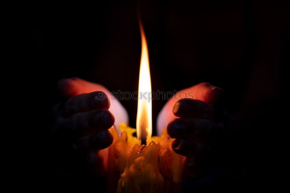 Similar – Image, Stock Photo many church candles with varying degrees of burn stuck in the sand in the dark. selective focus. dripping wax from one candle.