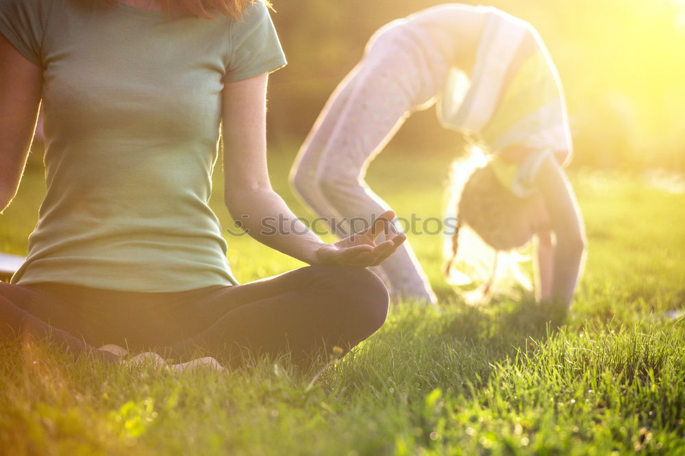 Similar – Image, Stock Photo Mother and daughter doing yoga exercises on grass in the park at the day time