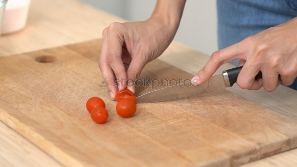 Similar – process of cutting slices of carrot on a kitchen board