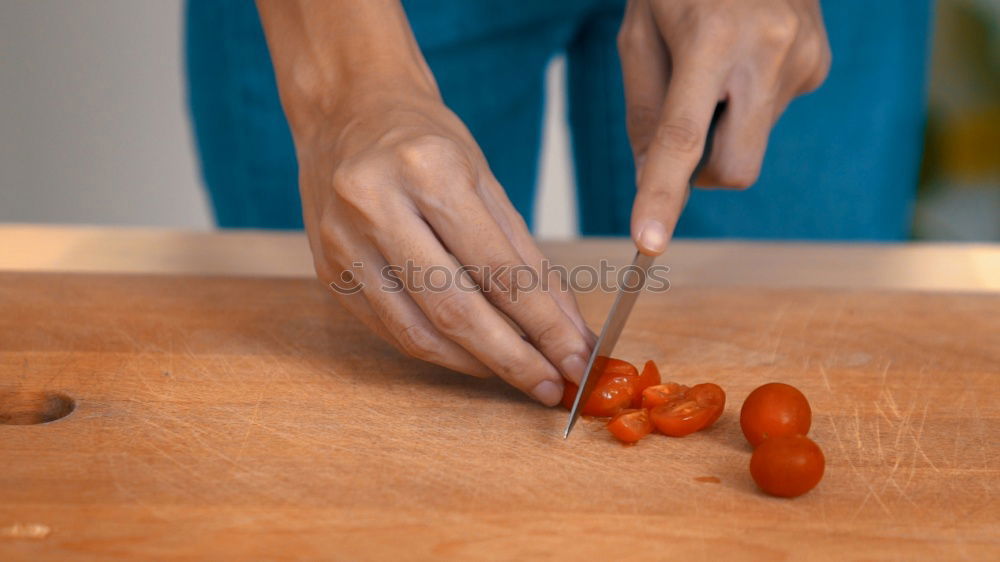 Girl tying baked Christmas gingerbread cookies with ribbon