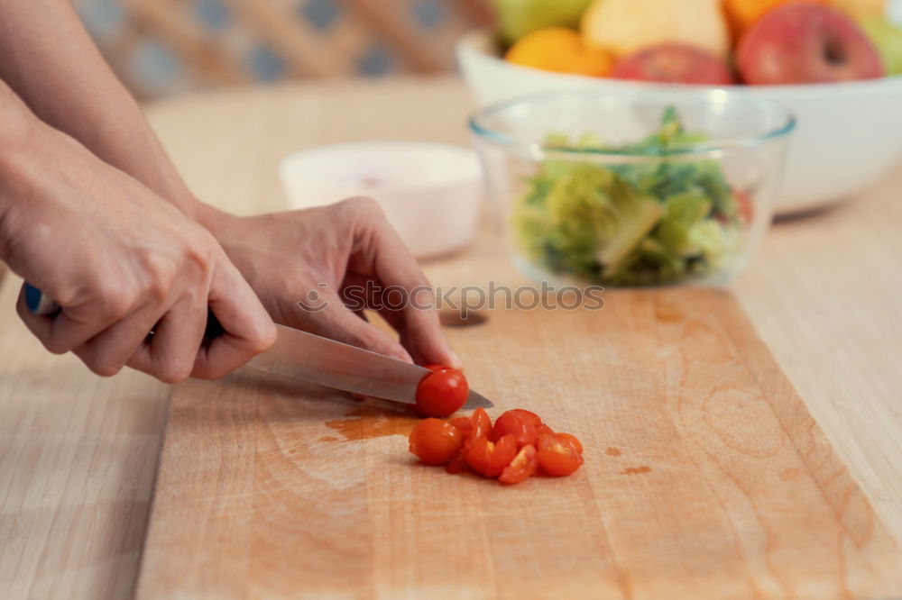 process of slicing carrots on slices on a kitchen board