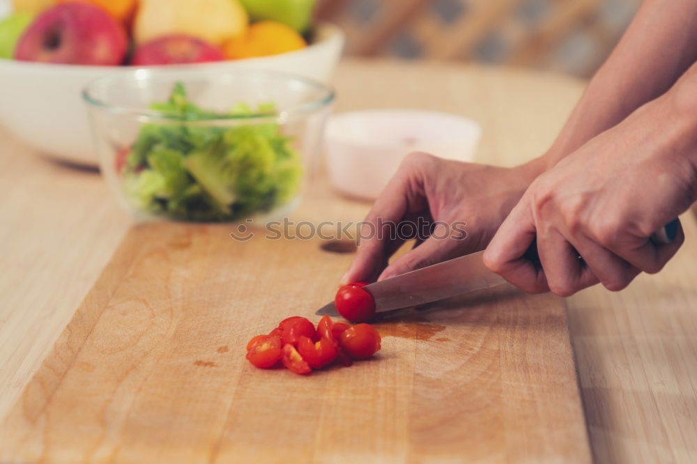 Similar – process of slicing carrots on slices on a kitchen board