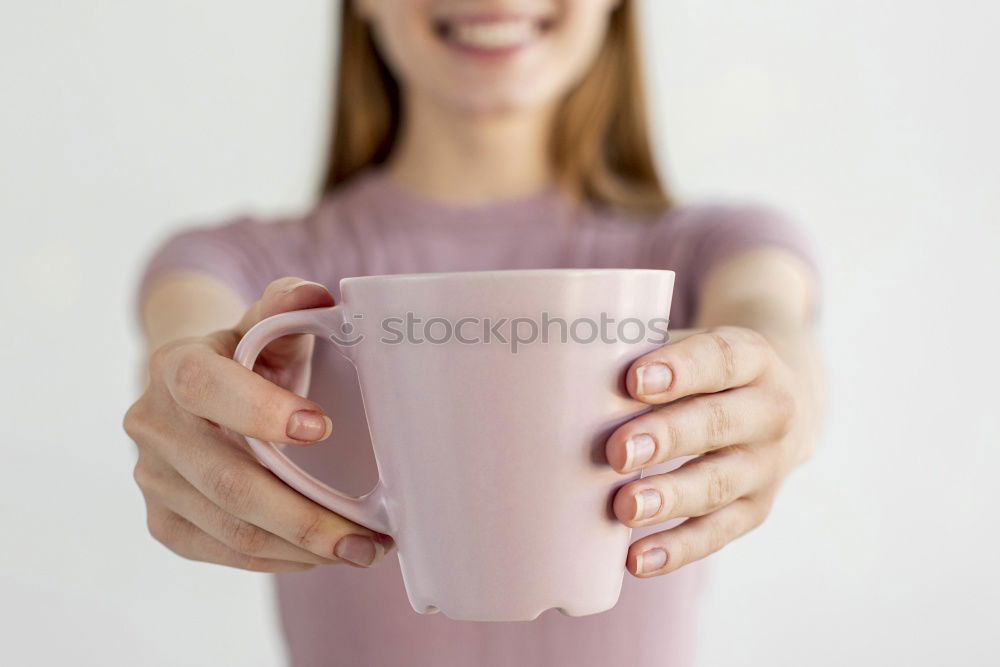 Similar – Happy young woman holding a cup of tea or coffee