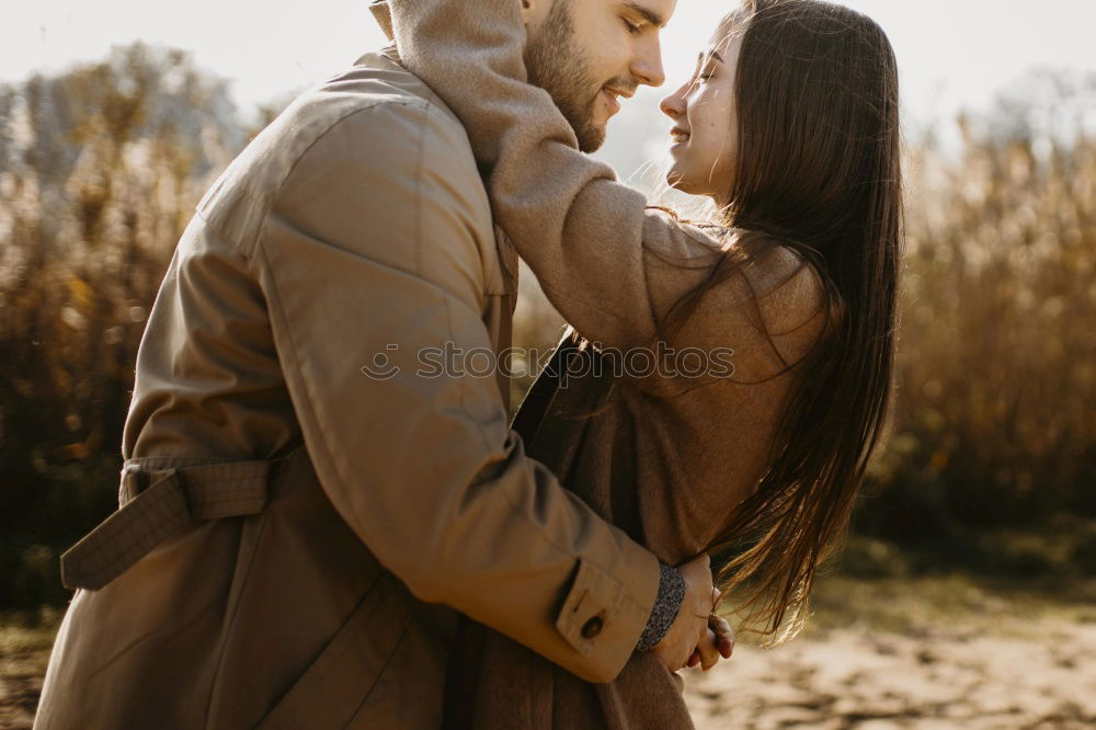 Smiling bearded man giving a piggy back to his girlfriend.