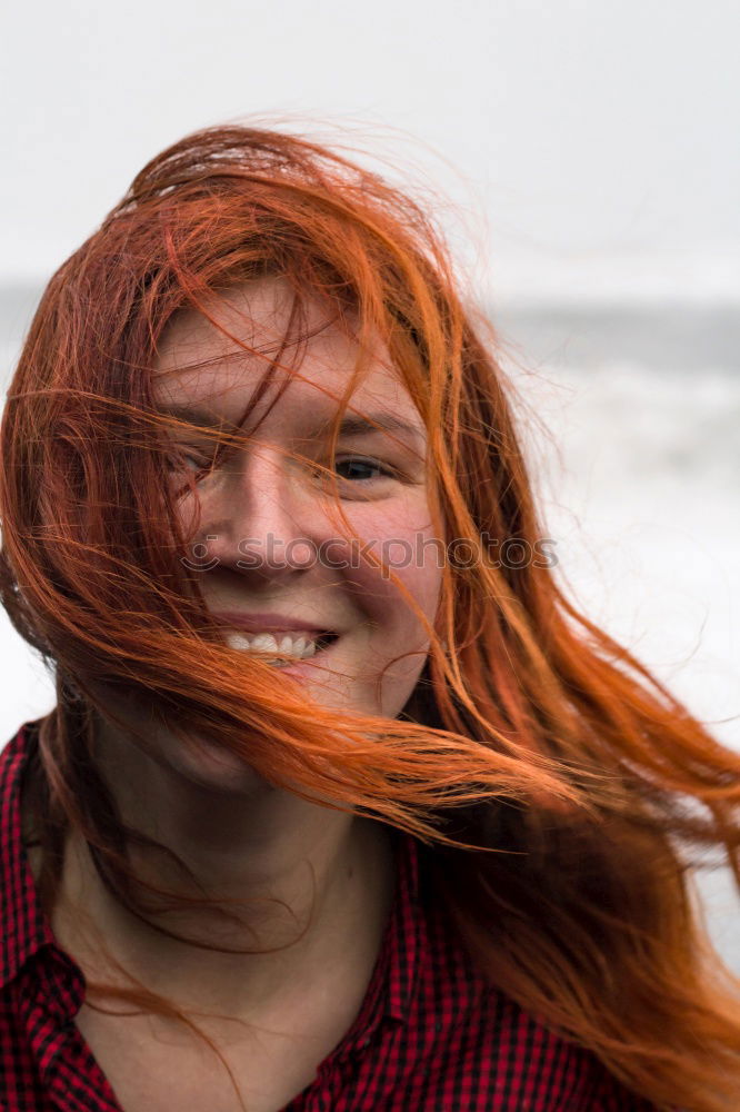 Similar – Portrait of an elderly woman with long red hair, looking mischievously to the side, with red jacket, black shirt and colourful necklace