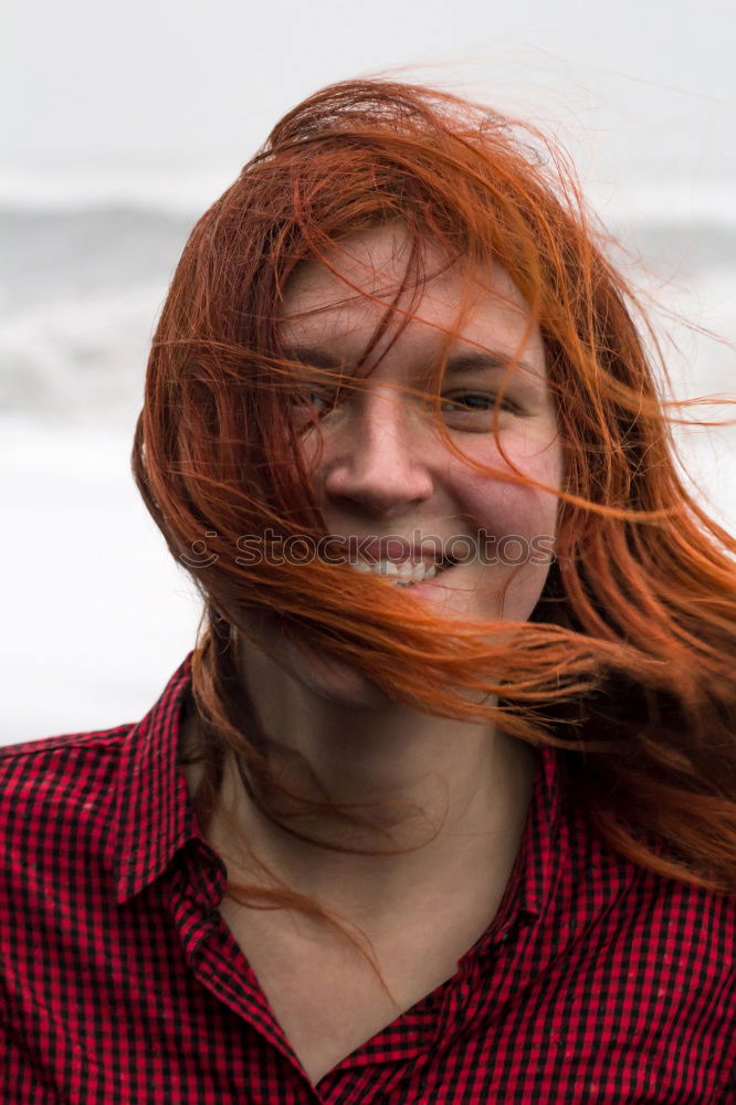 Similar – Portrait of an elderly woman with long red hair, looking mischievously to the side, with red jacket, black shirt and colourful necklace