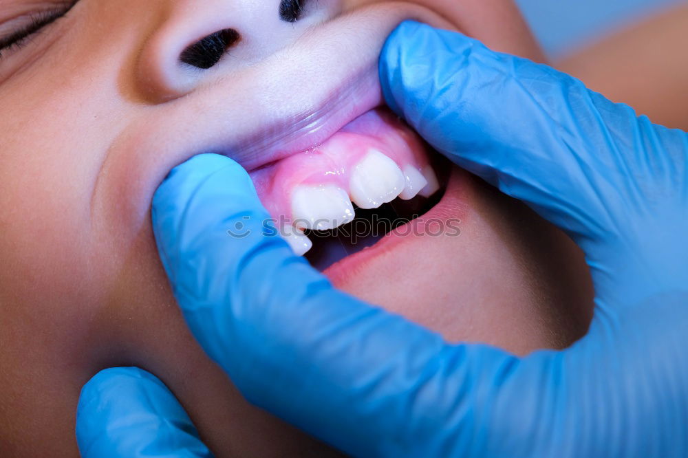 Similar – Seated young man is being examined his teeth by a dentist.