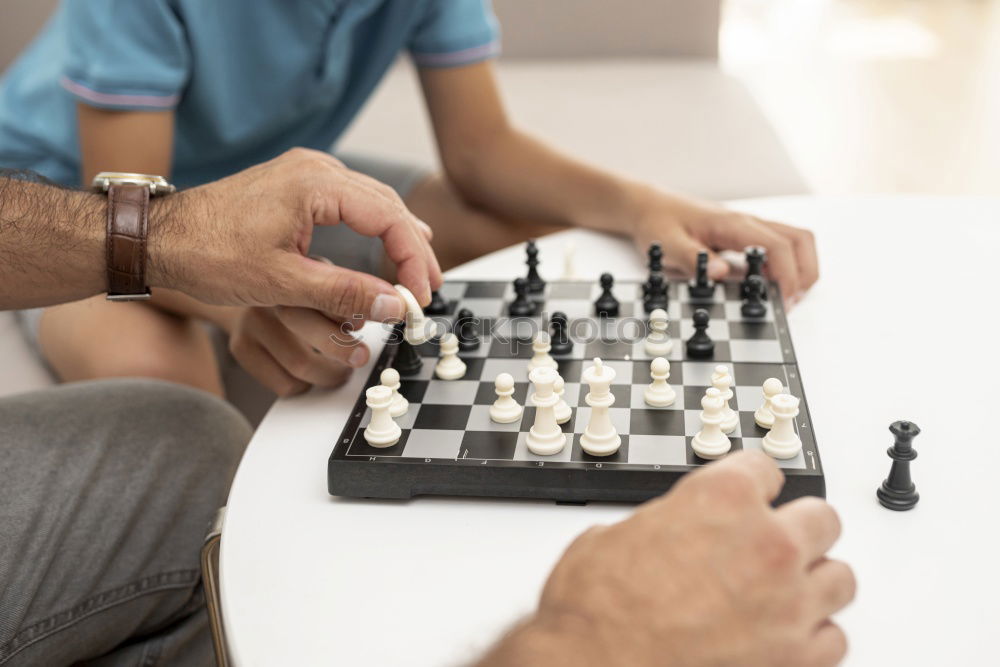 Similar – child girl playing checkers with dad