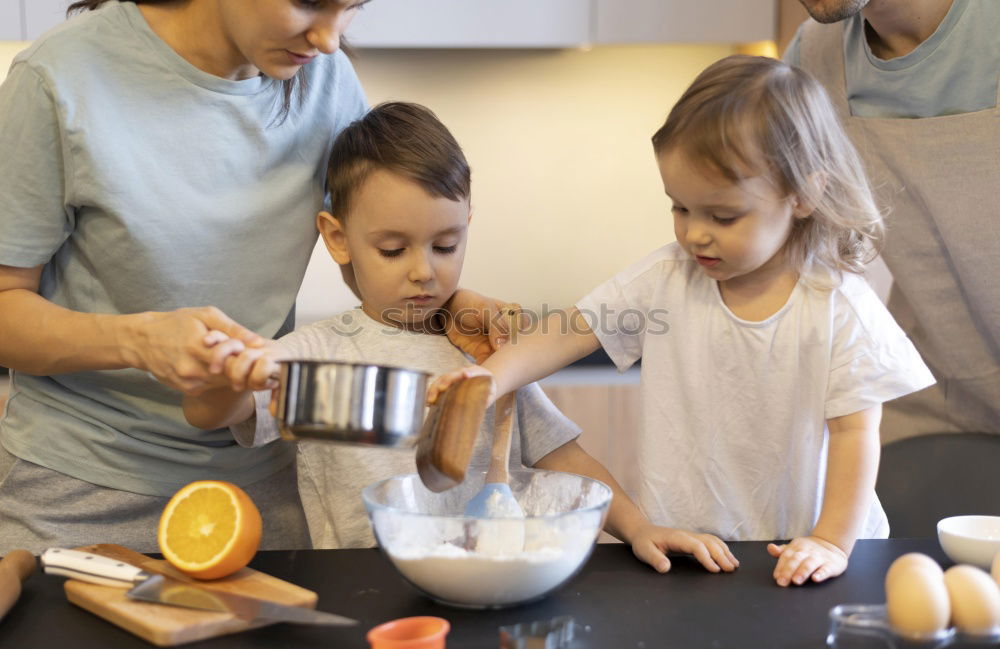 Similar – Image, Stock Photo Little sisters cooking with her mother in the kitchen.