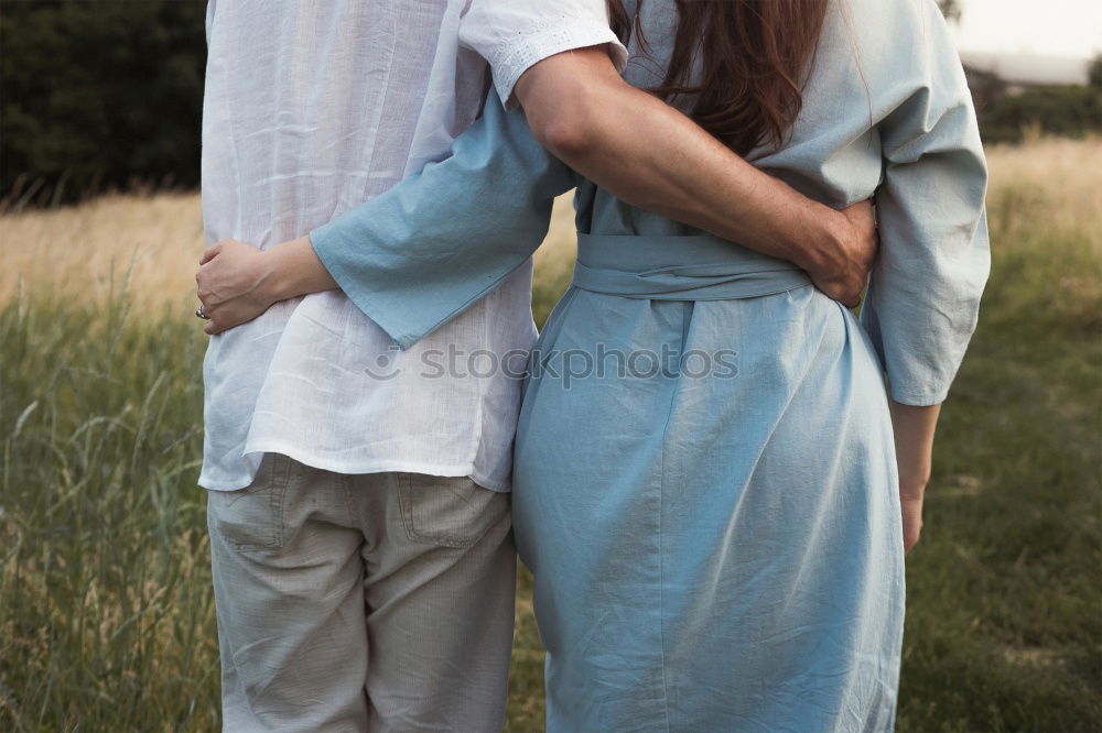 Similar – Image, Stock Photo Blonde woman and bearded man posing with plant branches in the hand at sunset, and blue sky in the background.