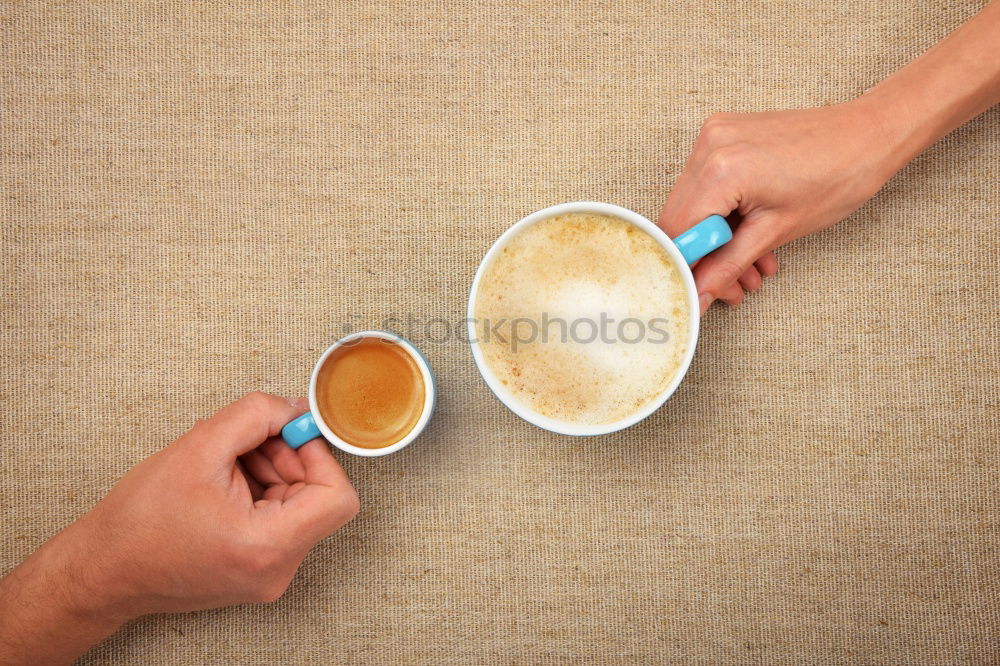 Similar – Two woman hands holding empty latte cappuccino coffee cup