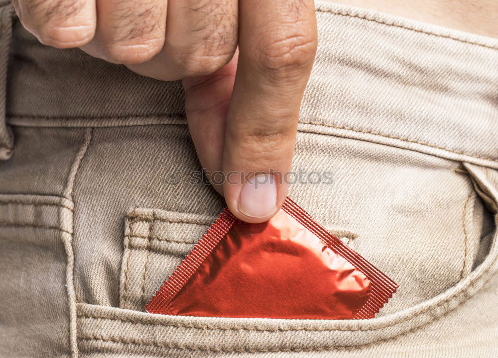 Similar – Image, Stock Photo the hand of a man who takes a condom in the pocket of his jeans