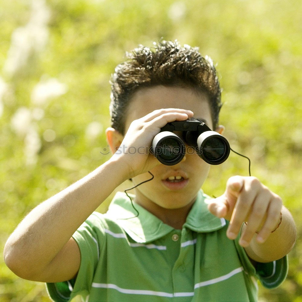 Similar – Foto Bild ein Mann blickt mit einem Fernglas durch einen Zaun