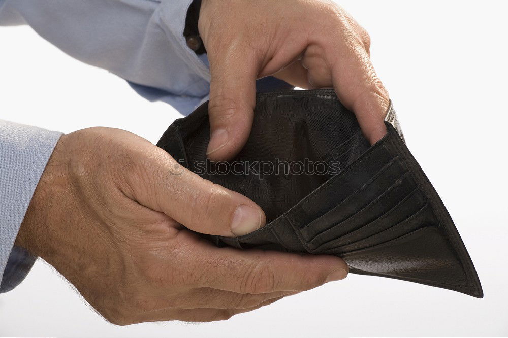 Similar – two female hands hold brown leather open empty wallet for cash