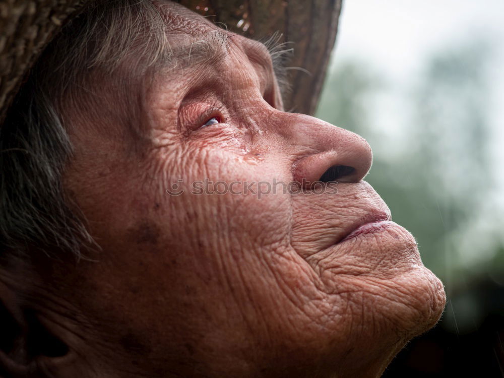 Senior citizen looks up in autumn forest