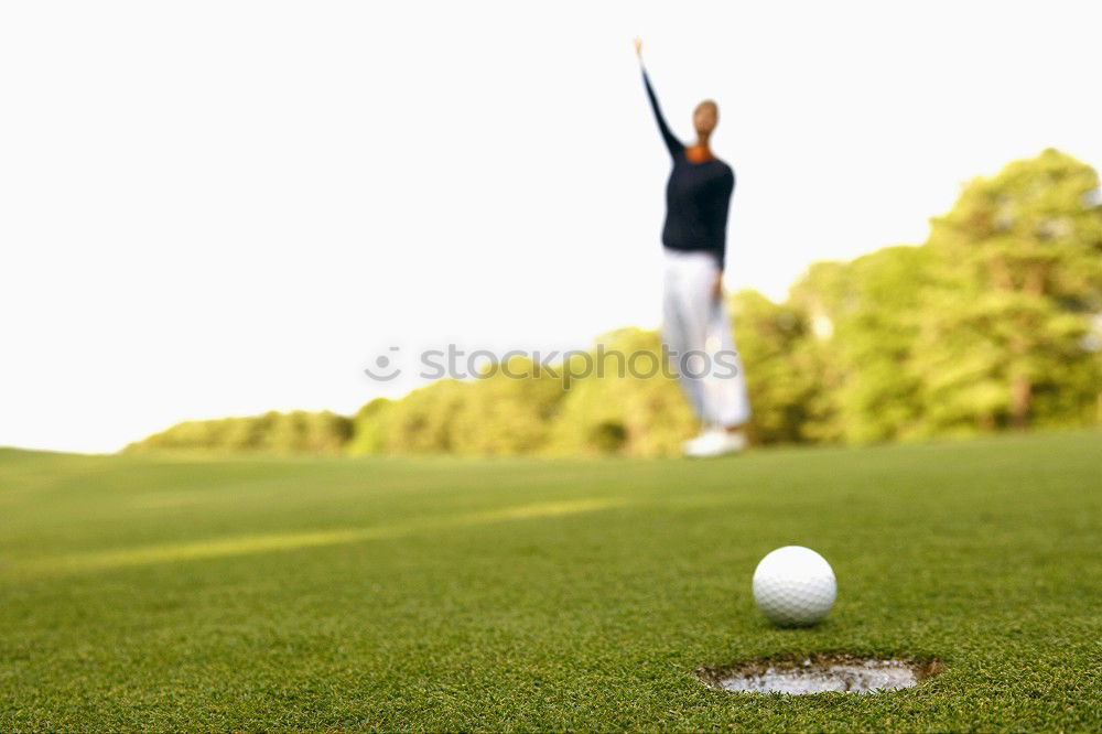 Golfer performs a golf shot from the fairway