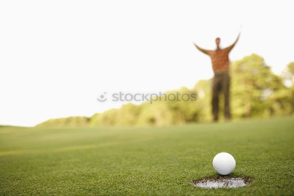 Similar – Golfer performs a golf shot from the fairway