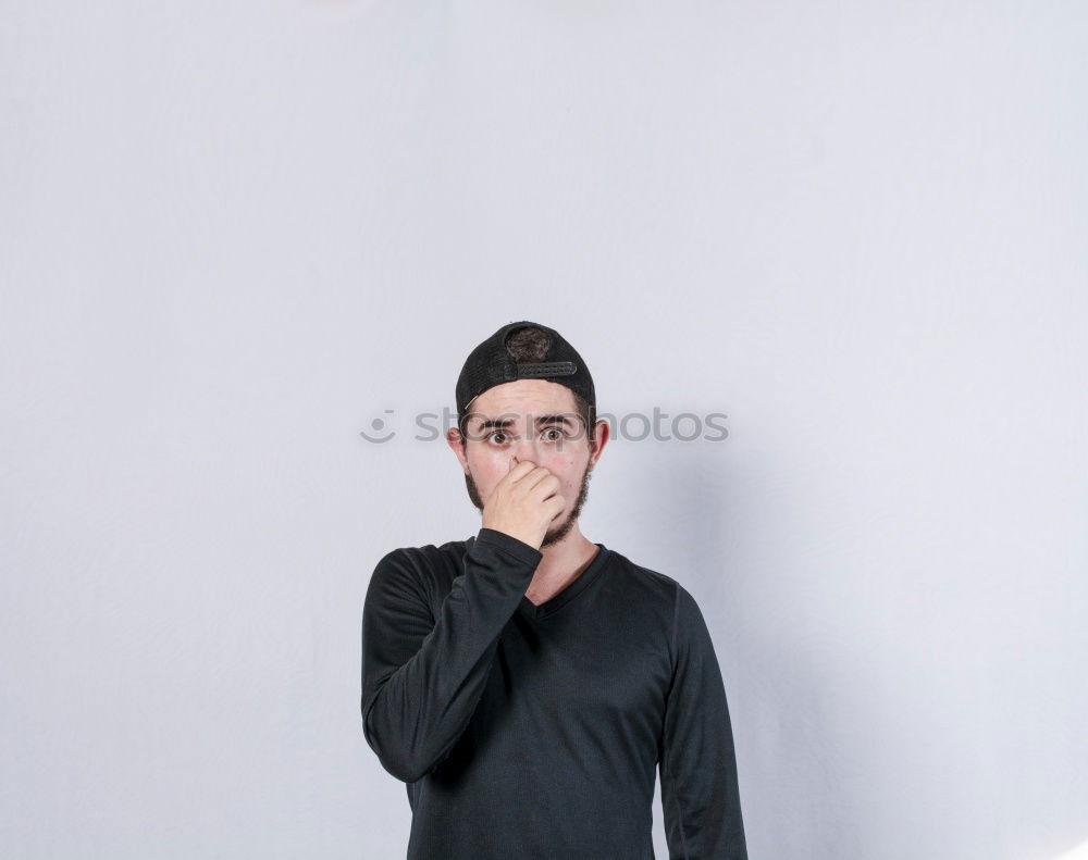 Similar – Boy with a white T-shirt in front of a dark wall